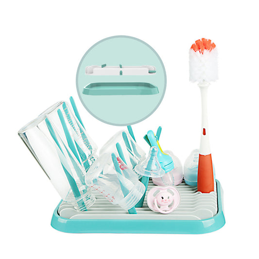 Turquoise dish drying rack with baby utensils and items on a white background