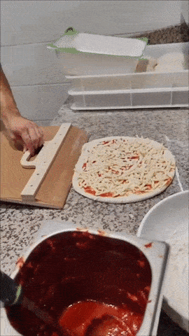 Pizza peel in action transferring a pizza