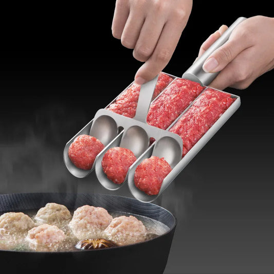 Person using a meatball maker to form ground meat into balls over a pot of boiling water.